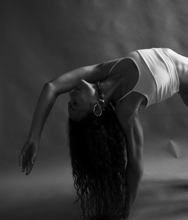Woman in a graceful yoga pose, symbolizing fluid movement and well-being.